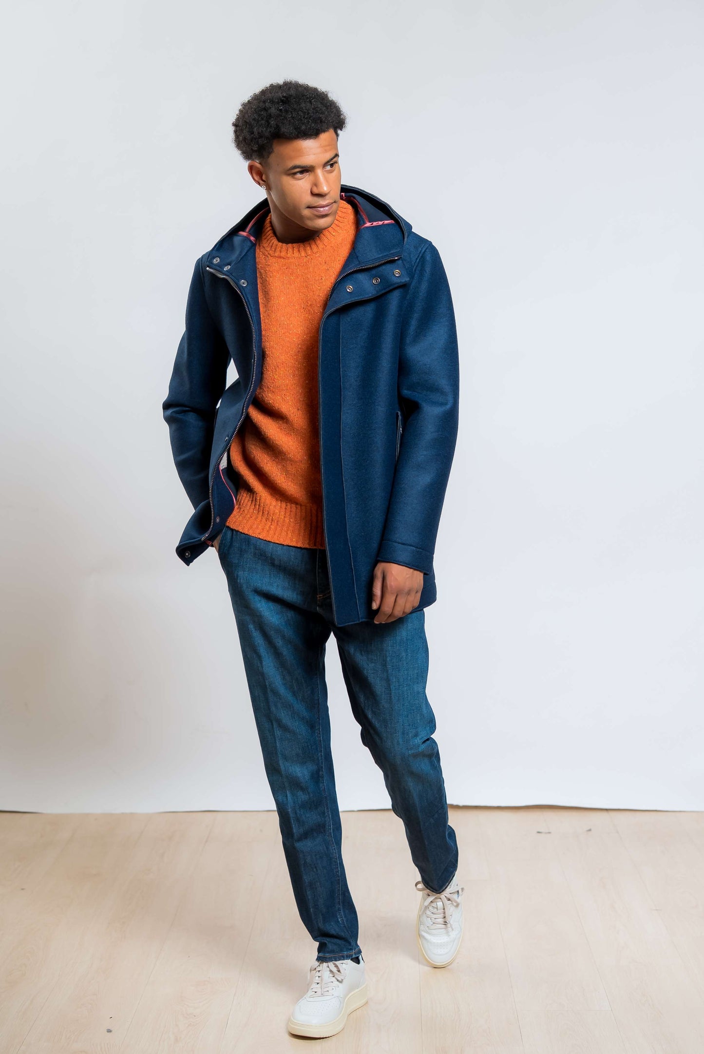 bob company cappotto wick con cappuccio in neoprene blu abbinato ad un maglione arancione e un jeans blu 