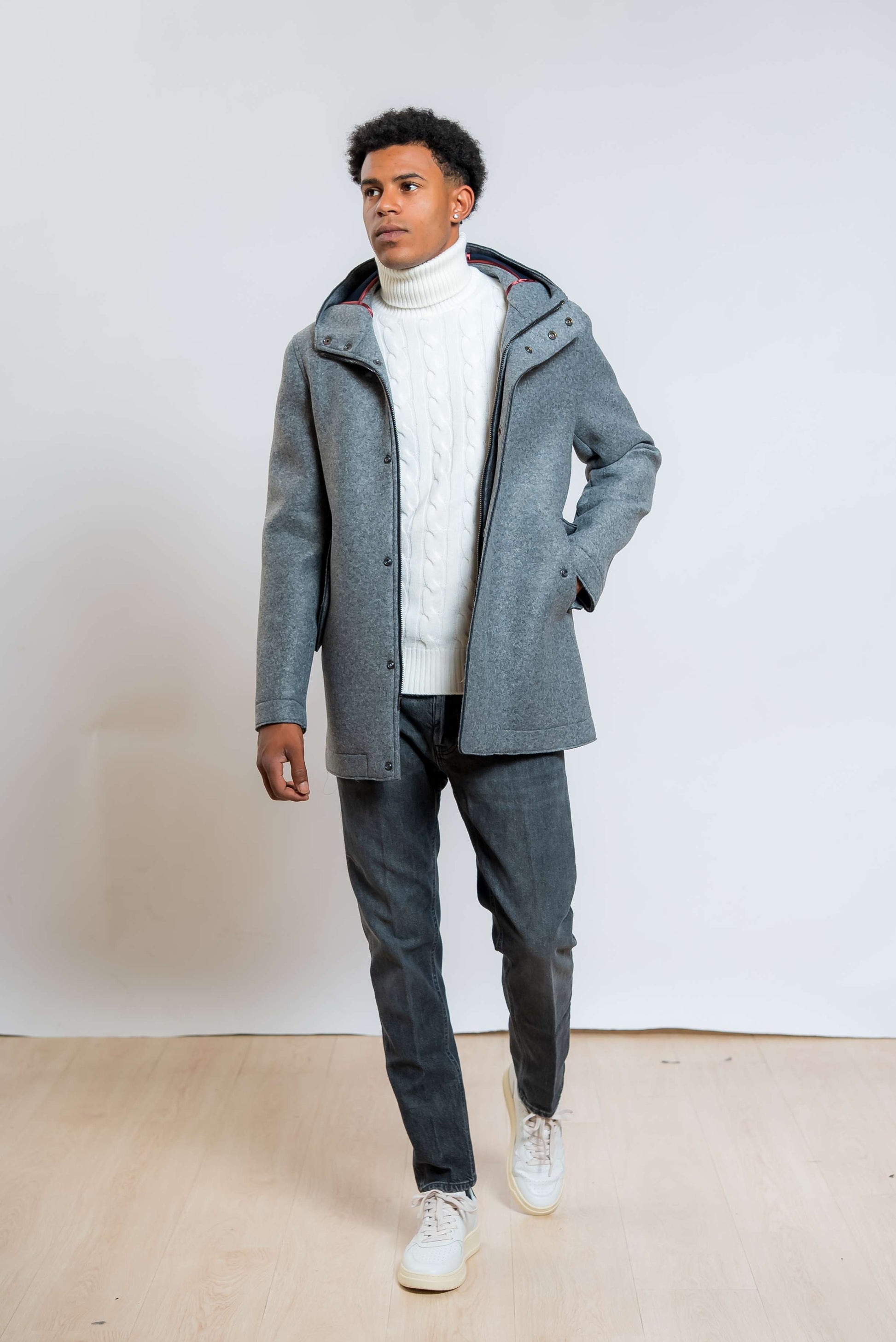 bob company cappotto wick con cappuccio in neoprene grigio abbinato ad un dolcevita bianco e un jeans grigio scuro