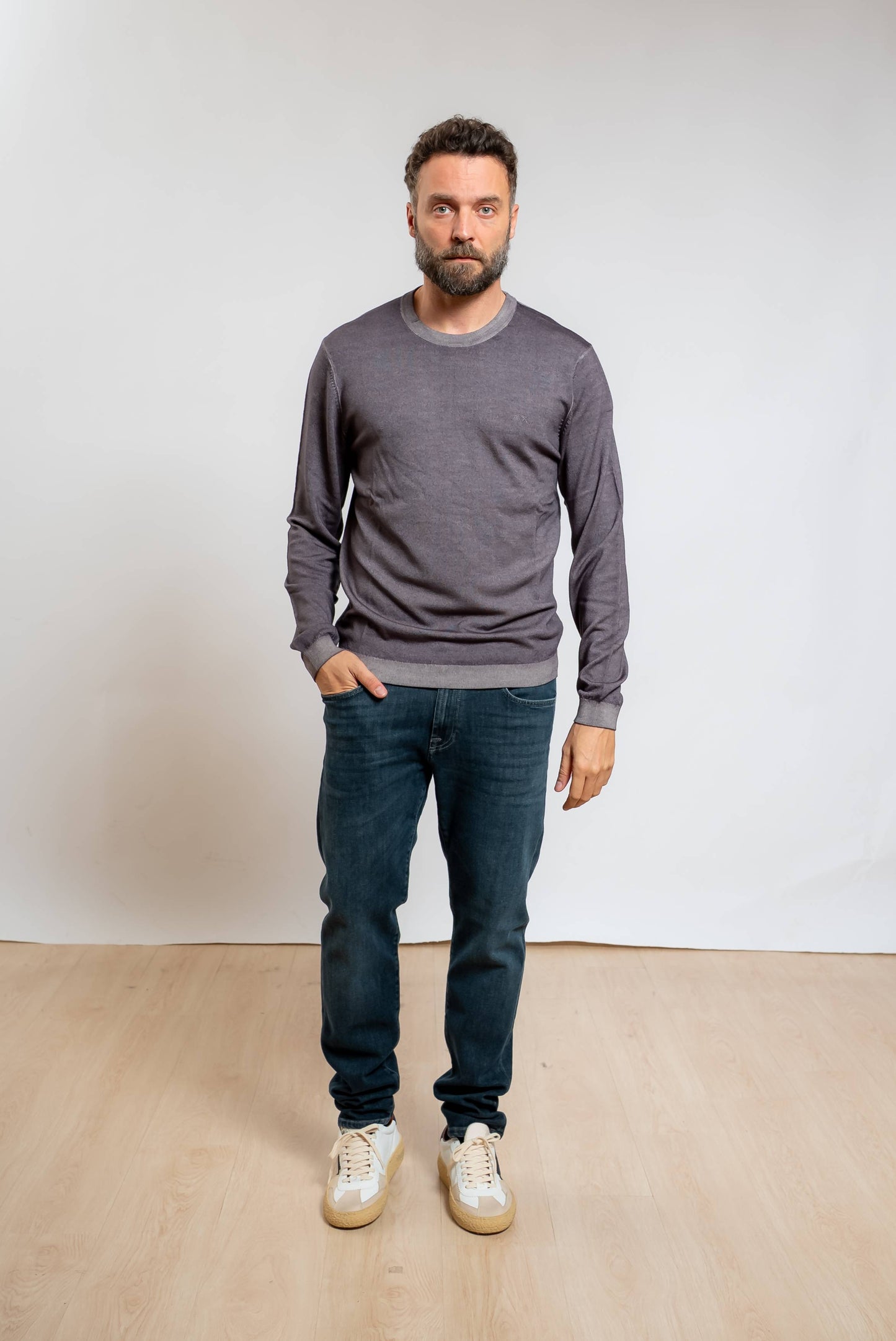 sun68 uomo maglia a girocollo in lana merino grigia con effetto vintage abbinata a jeans blu e sneakers bianche